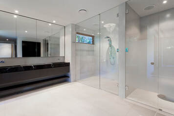 Picture of clean shower doors. There is total of four glass shower doors in this image.
