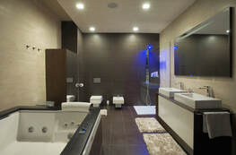 Picture of a more modern bathroom. This bathroom includes a hot tub.